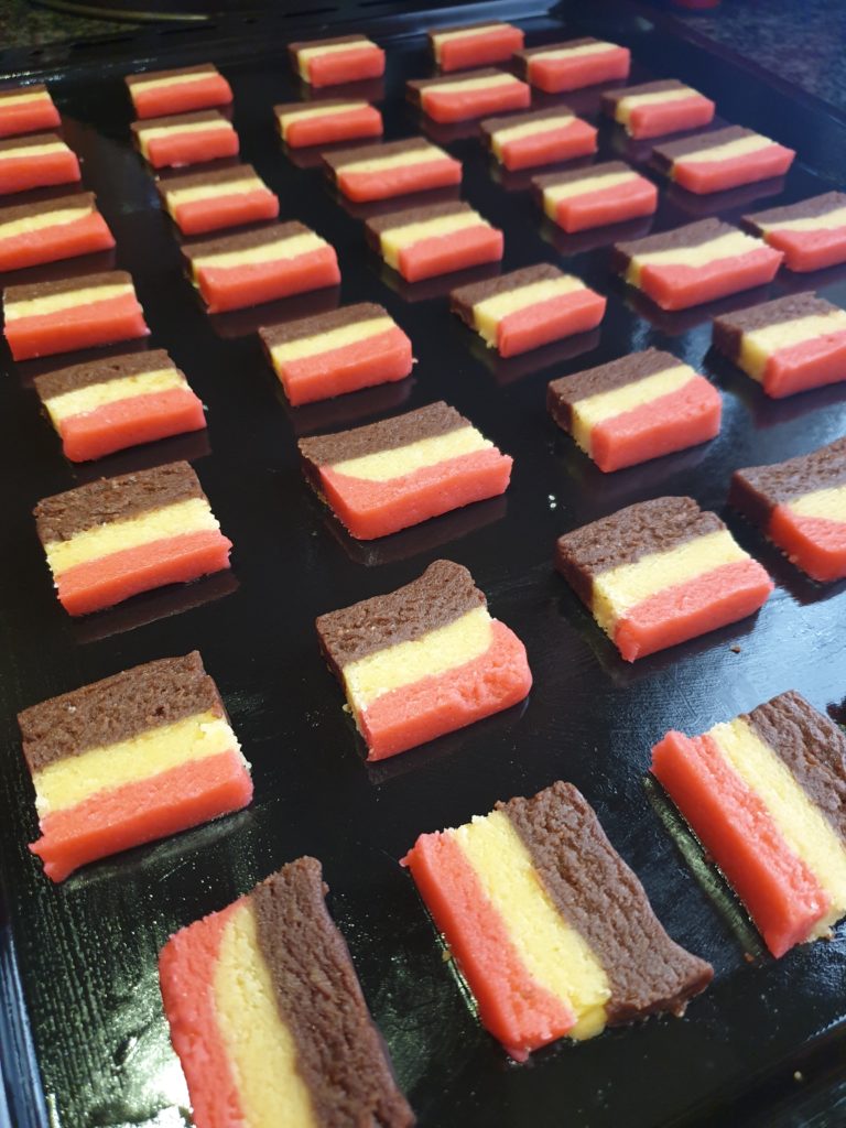 Sliced cookies on a baking tray ready for the oven.