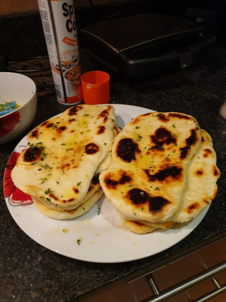 Baked and buttered naan bread